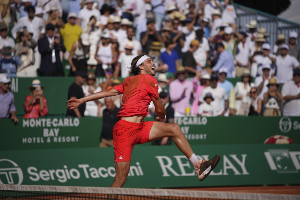 Stefanos Tsitsipas of Greece celebrates after winning the 2nd set against Casper Ruud of Norway to win the Monte Carlo Tennis Masters final match 6-1, 6-4 in Monaco, Sunday, April 14, 2024. (AP Photo/Daniel Cole)