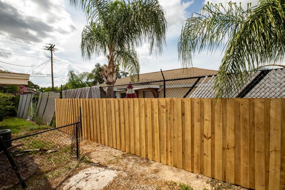 A newly installed, wooden privacy fence on John Murray's property mostly blocks views of the neighboring property to the north.