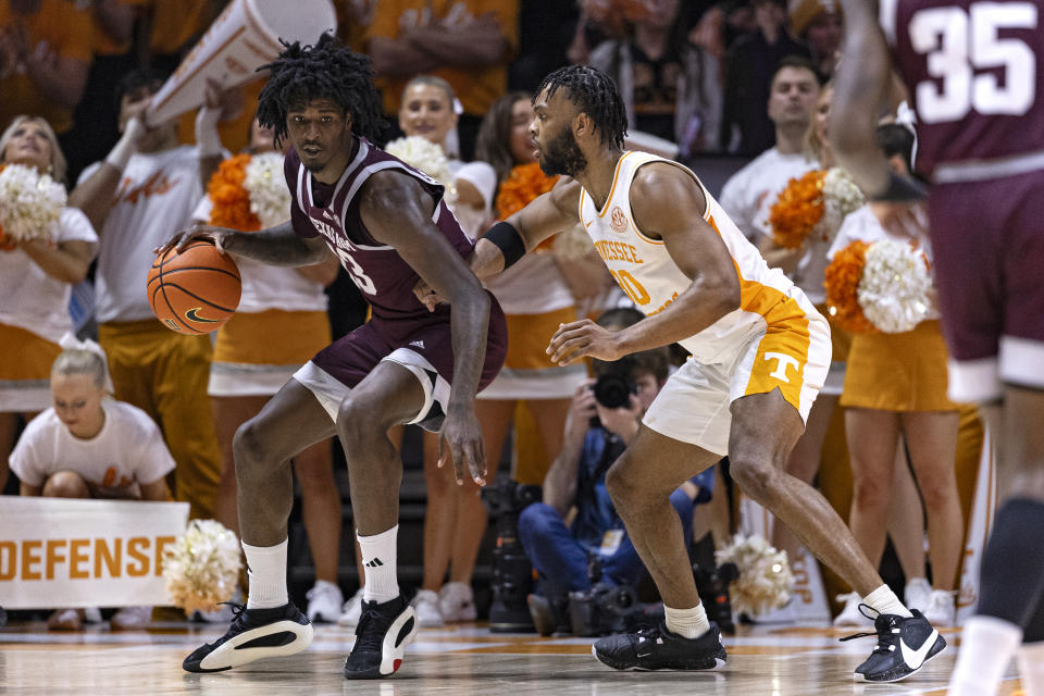 Texas A&M forward Solomon Washington, left, works for a shot as he is defended by Tennessee guard Josiah-Jordan James, right, during the first half of an NCAA college basketball game Saturday, Feb. 24, 2024, in Knoxville, Tenn. (AP Photo/Wade Payne)