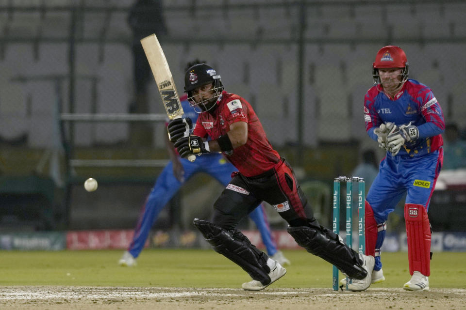 Lahore Qalandars' Abdullah Shafique, center, plays a shot as Karachi Kings' Tim Seifert, right, watches during the Pakistan Super League T20 cricket match between Lahore Qalandars and Karachi Kings, in Karachi, Pakistan, Saturday, March 9, 2024. (AP Photo/Fareed Khan)