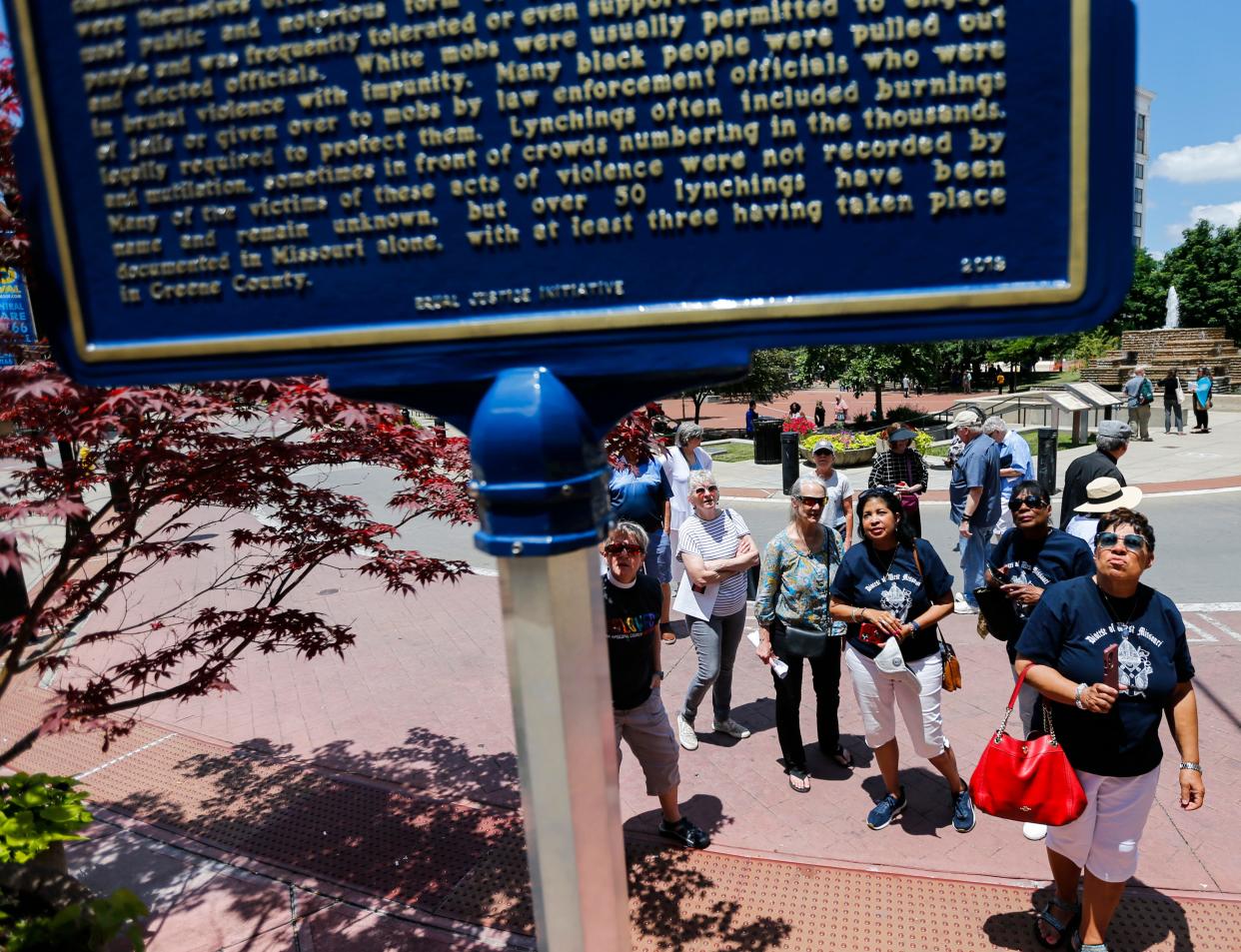 A group of Episcopal priests from across Missouri look at a historical marker that honors three African American men, Horace Duncan, Fred Coker, and William Allen, who were lynched in downtown Springfield in 1906, during a Juneteenth pilgrimage to Springfield on Monday, June 19, 2023.