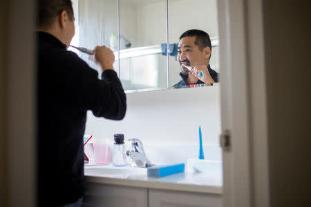 Scott Ozawa brushes his teeth with a Beam toothbrush at his home in Belmont, California, U.S. December 18, 2016. Picture taken December 18, 2016. REUTERS/Noah Berger