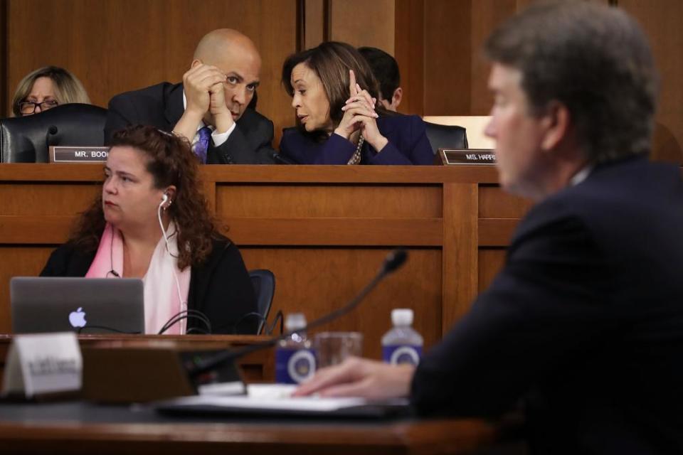 Senators Cory Booker and Kamala Harris confer as the then supreme court nominee Brett Kavanaugh testifies on Capitol Hill in September 2018.