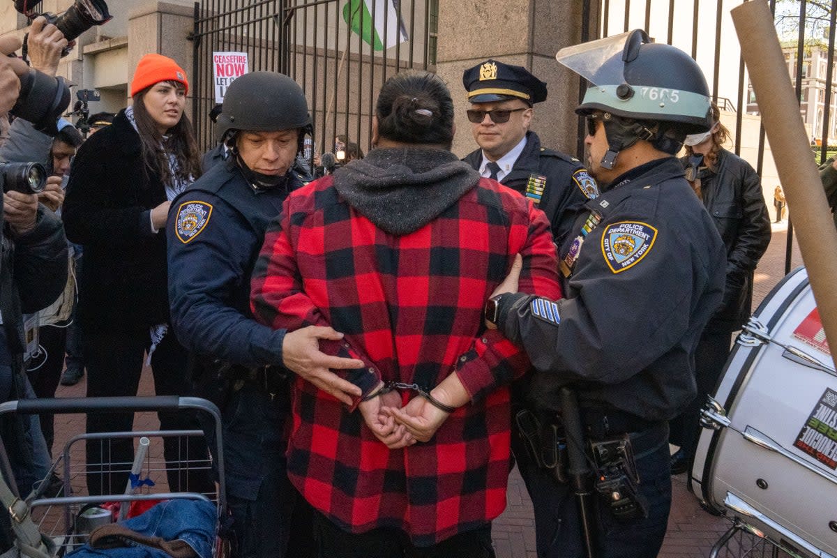 A Pro-Palestine protestor is arrested at the gates of Columbia University on 22 April 2024 in New York City (Getty Images)