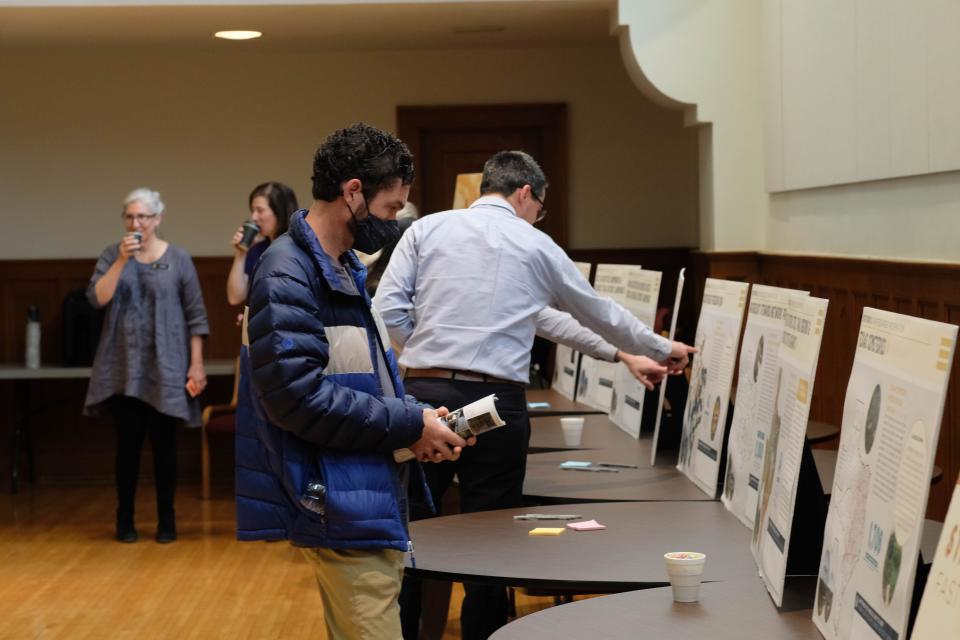 Guests at the Texas Historical Commission's preservation event look over the interactive displays at the Sante Fe Building Auditorium Thursday.