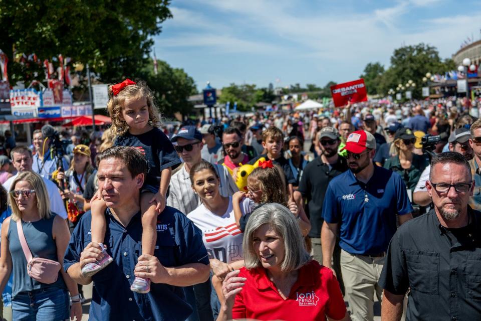 Republican presidential candidate Gov. Ron DeSantis of Florida carries his daughter Madison while walking through the Iowa State Fair in Des Moines on Aug. 12, 2023. <a href="https://www.gettyimages.com/detail/news-photo/republican-presidential-candidate-florida-gov-ron-desantis-news-photo/1610098448?adppopup=true" rel="nofollow noopener" target="_blank" data-ylk="slk:Brandon Bell/Getty Images;elm:context_link;itc:0;sec:content-canvas" class="link ">Brandon Bell/Getty Images</a>