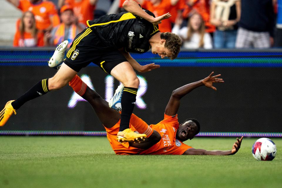 FC Cincinnati forward Dominique Badji (14) is fouled by Columbus Crew defender Philip Quinton (2) in the goal box in the first half of FC Cincinnati and Columbus Crew play at TQL Stadium in Cincinnati on Saturday, May 20, 2023.