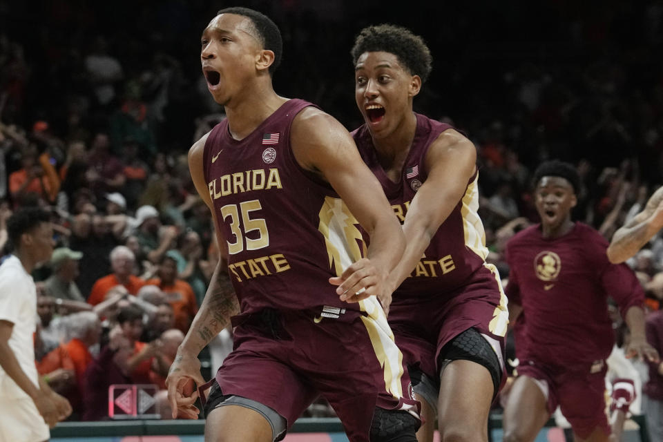 Florida State guard Matthew Cleveland (35), right, reacts after scoring the winning basket during the second half of an NCAA college basketball game against Miami, Saturday, Feb. 25, 2023, in Coral Gables, Fla. Florida State defeated Miami 85-84. (AP Photo/Marta Lavandier)