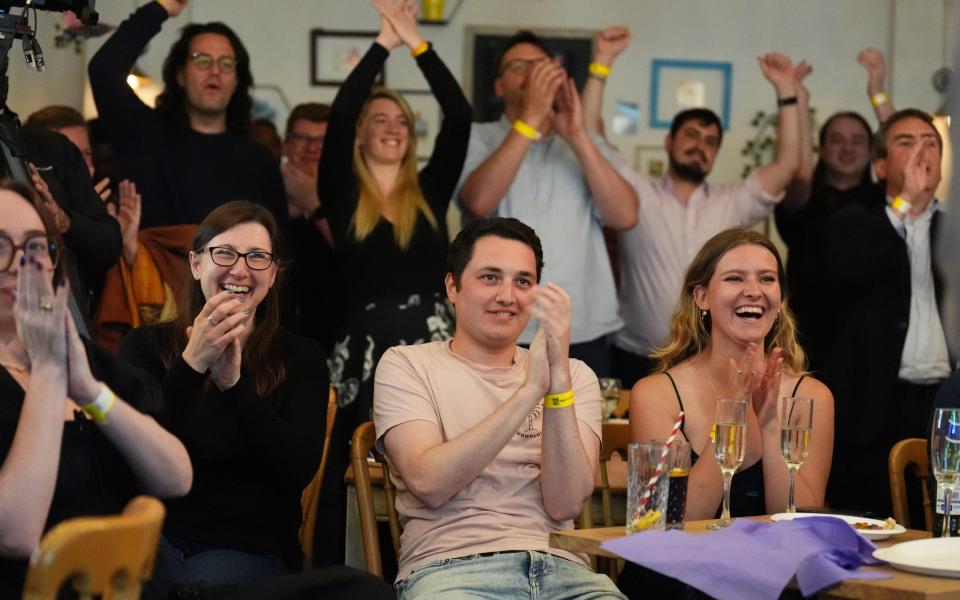 Liberal Democrat supporters celebrate at an election results watch party at the London Art Bar, central London, as party leader Sir Ed Davey wins his seat