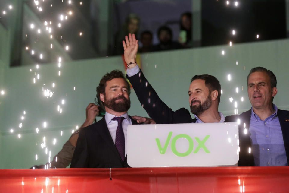 Santiago Abascal, leader of far-right Vox Party, waves to supporters as fireworks go off outside the party headquarters after the announcement of the general election first results, in Madrid, Sunday, Nov. 10, 2019. Celebrating the 52 seats won in the parliament's lower house, more than double than the 24 it received in April, Abascal vowed to use Vox's position as Spain's third political force to hardened policies against illegal immigration, laws against abortion and the crack down on separatists in Catalonia and elsewhere. (AP Photo/Andrea Comas)