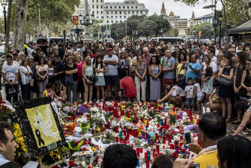 People pay respect at a memorial tribute of flowers, messages and candles to the victims on Barcelona on August 19, 2017, two days after a van plowed into the crowd, killing 14 persons and injuring over 100. Another two victims died in later attacks. File Photo by Angel Garcia/UPI