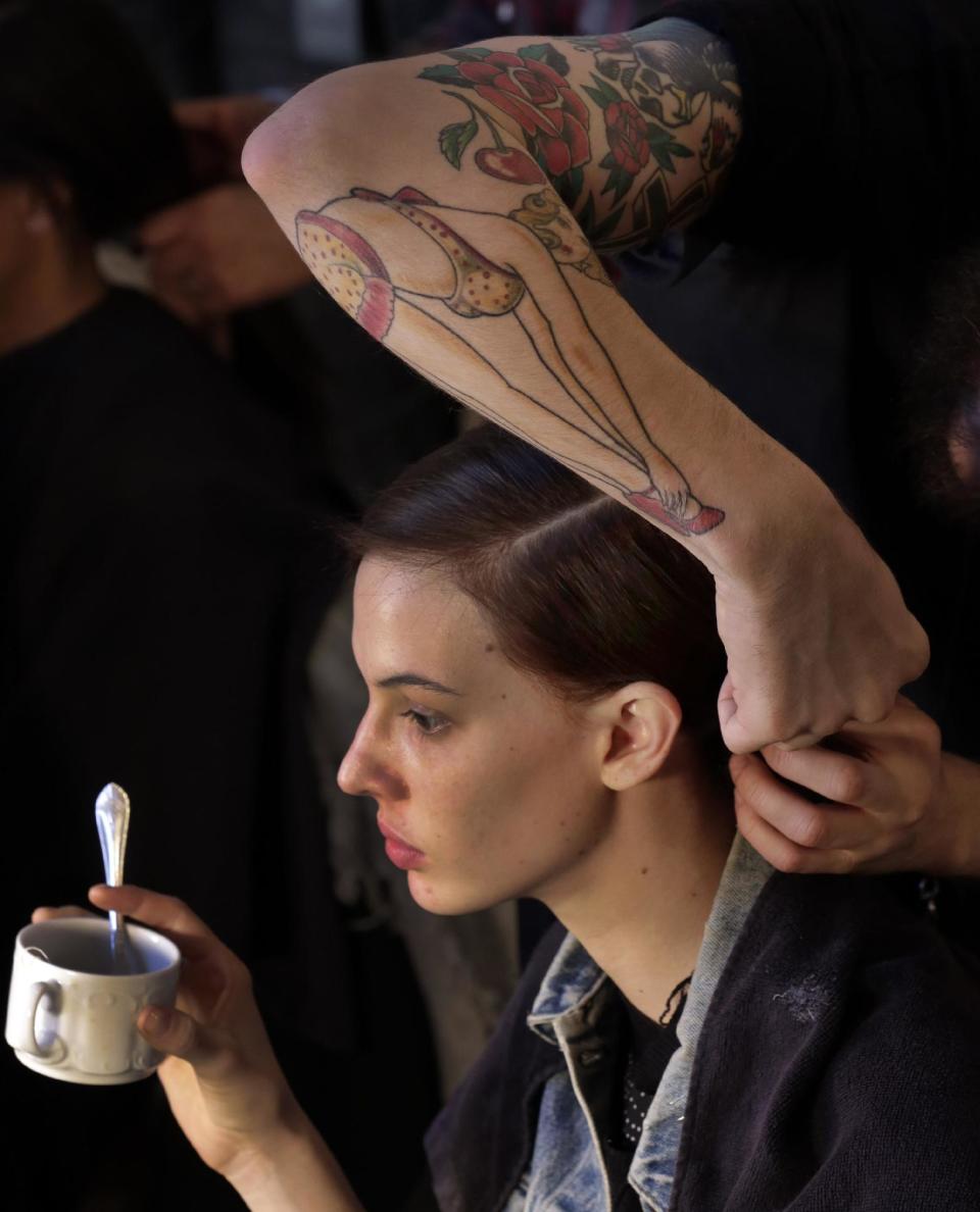 A model has her hair styled backstage before the Tory Burch Fall 2013 collection is modeled during Fashion Week in New York, Tuesday, Feb. 12, 2013. (AP Photo/Richard Drew)