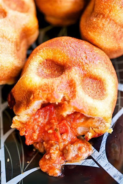 <p>Get yourself a skull-shaped pan, some pizza dough, sauce, and fillings, and you've got yourself a great night of food. </p><p><strong>Get the recipe at </strong><strong><a rel="nofollow noopener" href="https://www.amazon.com/gp/product/B00Y6PRETK/" target="_blank" data-ylk="slk:Plain Chicken.;elm:context_link;itc:0;sec:content-canvas" class="link ">Plain Chicken.</a></strong></p><p><strong>Tools you'll need: </strong>haunted skull cakelet pan ($39, <a rel="nofollow noopener" href="https://www.amazon.com/gp/product/B00Y6PRETK/" target="_blank" data-ylk="slk:amazon.com;elm:context_link;itc:0;sec:content-canvas" class="link ">amazon.com</a>)</p>