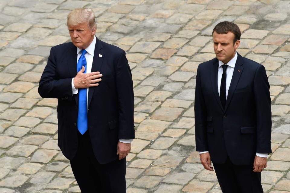 Trump&nbsp;and French President Emmanuel Macron stand during the US and French national anthems.&nbsp;