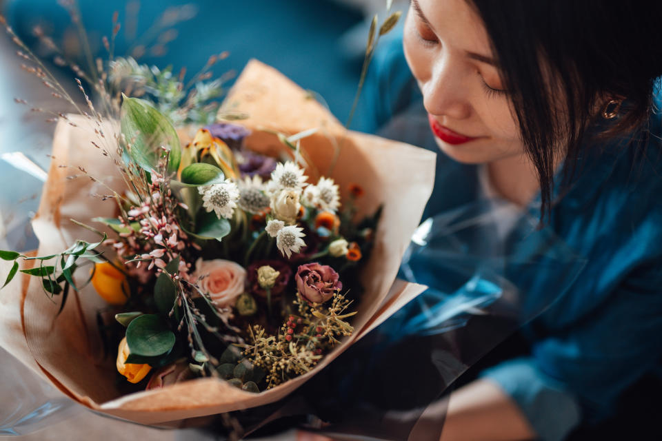 Woman receiving bouquet of flowers