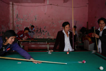 Ethnic Lisu men play a game of billiards in Daxindi township of Nujiang Lisu Autonomous Prefecture in Yunnan province, China, March 24, 2018. REUTERS/Aly Song