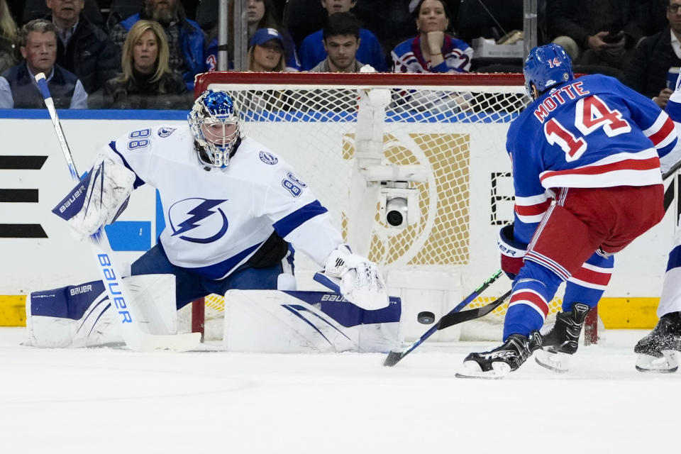 Tampa Bay Lightning goaltender Andrei Vasilevskiy (88) stops a shot by New York Rangers' Tyler Motte (14) during the first period of an NHL hockey game Wednesday, April 5, 2023, in New York. (AP Photo/Frank Franklin II)