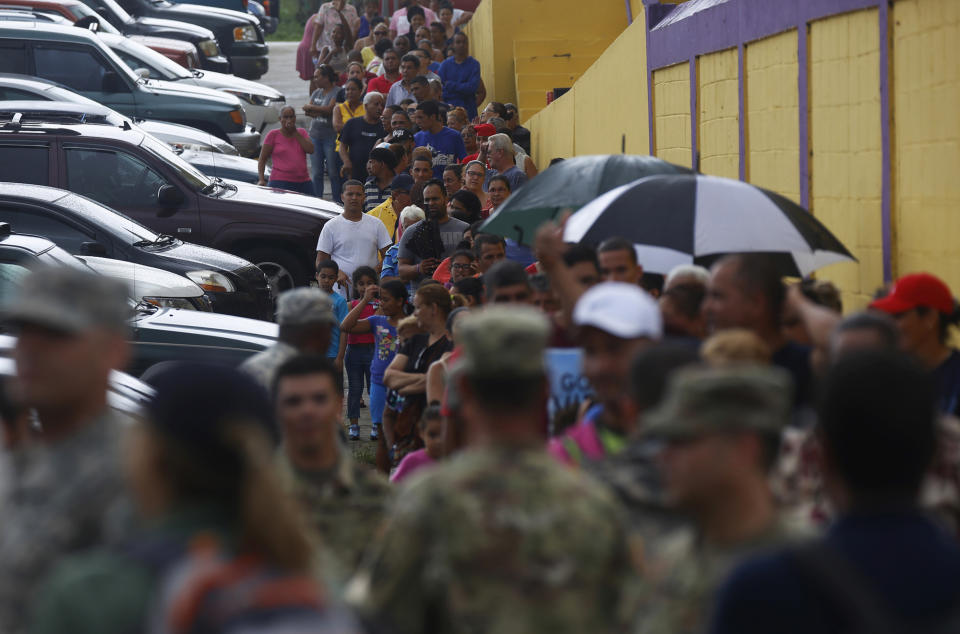 <p>Victims of Hurricane Maria line up to receive supplies from members of the U.S. military, in Las Piedras, Puerto Rico, Oct. 18, 2017. (Photo: Thais Llorca/EPA-EFE/REX/Shutterstock) </p>