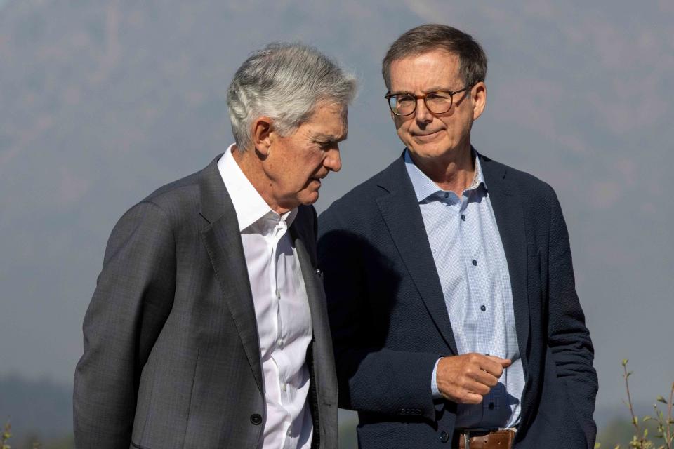 <p>Natalie Behring/Bloomberg via Getty Images</p> Jerome Powell, chair of the Federal Reserve, left, and Tiff Macklem, governor of the Bank of Canada, during the Kansas City Federal Reserve