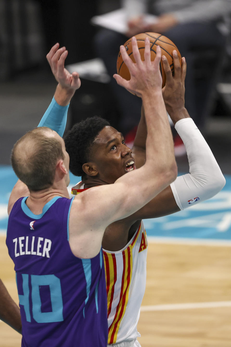 Atlanta Hawks forward Nathan Knight, right, shoots against Charlotte Hornets center Cody Zeller (40) during the second quarter of an NBA basketball game in Charlotte, N.C., Sunday, April 11, 2021. (AP Photo/Nell Redmond)