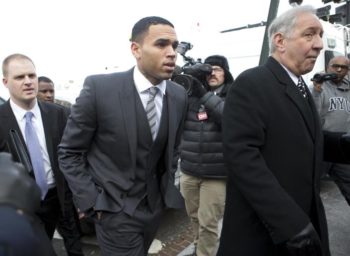 Singer Chris Brown, center, arrives at the District of Columbia Superior Court in Washington, Wednesday, Jan. 8, 2014, for a status hearing in a case in which he's accused of hitting a man outside a Washingtonhotel. The R&B singer was arrested in October after a man said the singer hit him outside the W Hotel. Brown and his bodyguard each face a misdemeanor assault charge. (AP Photo/Manuel Balce Ceneta)