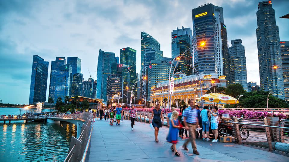 Singapore is expensive and hot -- but offers great job prospects and food. Here, people take a stroll along the marina bay. - Andriy Kravchenko/Alamy Stock Photo