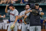 Cleveland Guardians players celebrate winning the American League Central after defeating the Texas Rangers in a baseball game in Arlington, Texas, Sunday, Sept. 25, 2022. (AP Photo/Gareth Patterson)