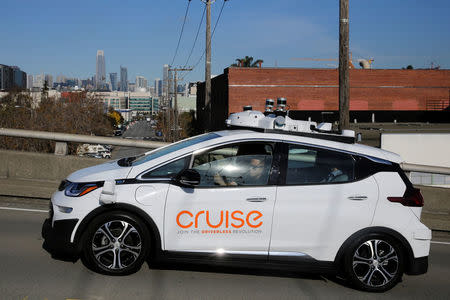 The San Francisco skyline is seen behind a self-driving GM Bolt EV during a media event where Cruise, GM's autonomous car unit, showed off its self-driving cars in San Francisco, California, U.S. November 28, 2017. REUTERS/Elijah Nouvelage