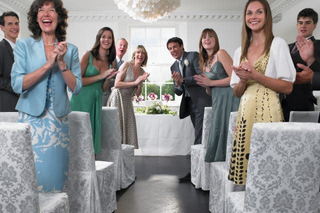 Wedding guests looking down aisle