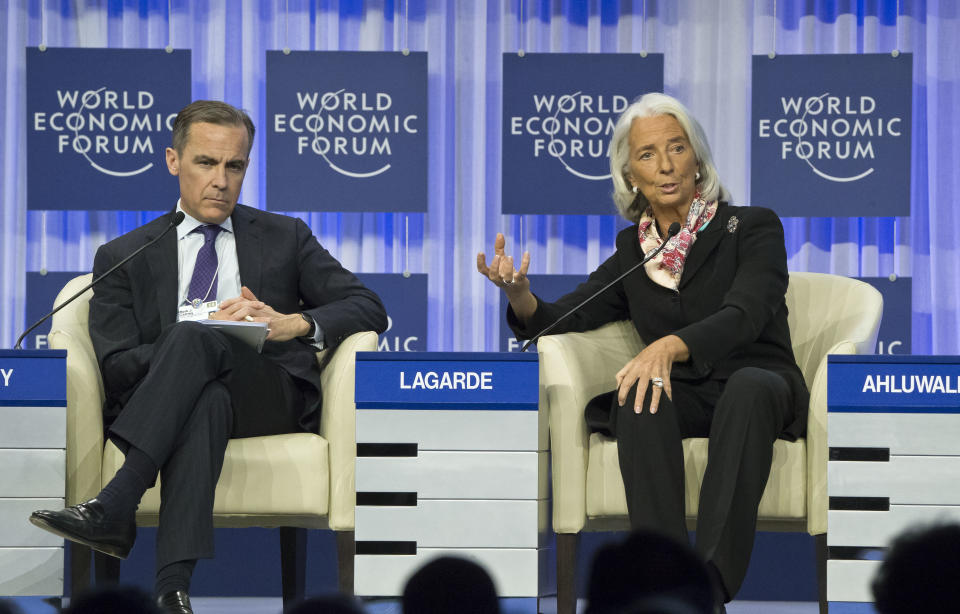 Head of the International Monetary Fund Christine Lagarde, right, gestures as she speaks while Governor of the Bank of England Mark J. Carney, sits next to her during a session at the World Economic Forum in Davos, Switzerland, Saturday, Jan. 25, 2014. (AP Photo/Michel Euler)