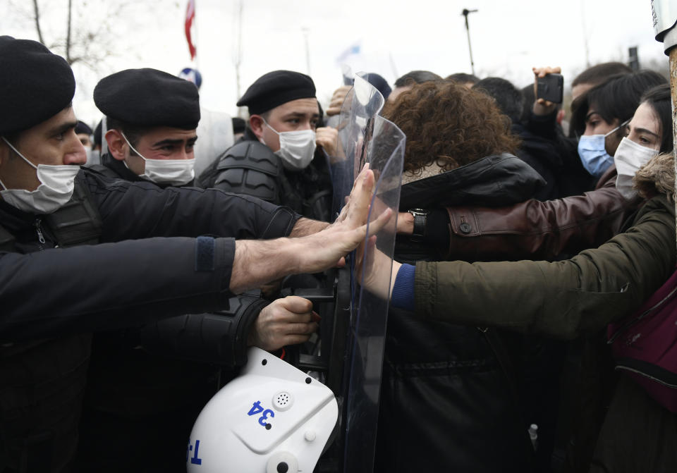 Turkish police officers clash with students of the Bogazici University protesting the appointment of a government loyalist to head their university, in Istanbul, Tuesday, Feb. 2, 2021. For weeks, students and faculty at Istanbul's prestigious Bogazici University have been protesting President Recep Tayyip Erdogan's appointment of Melih Bulu, a figure who has links to his ruling party, as the university's rector. They have been calling for Bulu's resignation and for the university to be allowed to elect its own president. (AP Photo/Omer Kuscu)