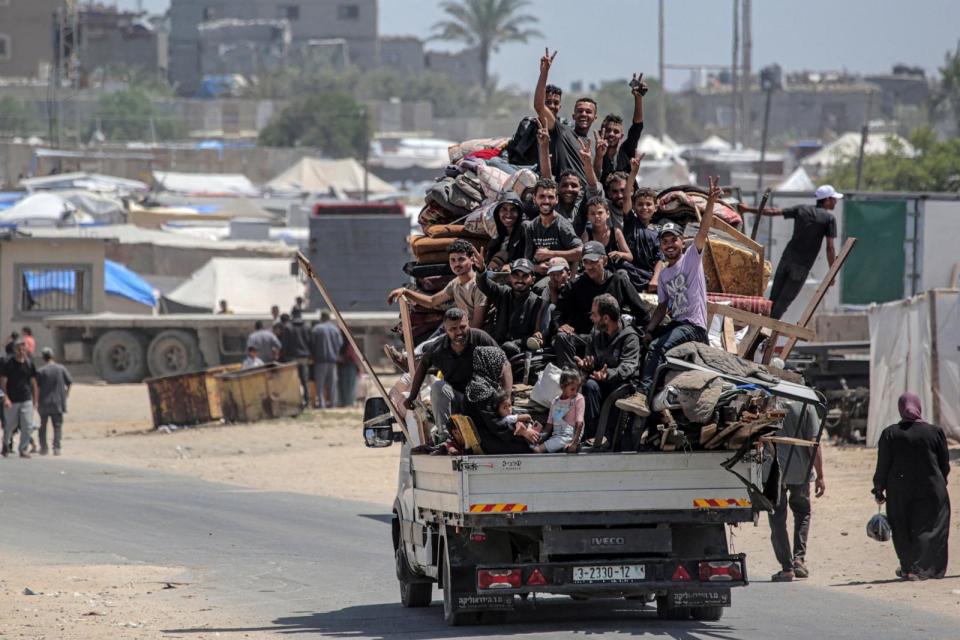 PHOTO: Palestinian who fled Rafah in the southern Gaza Strip ride with their belongings in the back of a truck, as they arrive to take shelter in Deir el-Balah in the central part of the Palestinian territory on May 12, 2024. (Said Khatib/AFP via Getty Images)