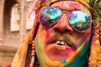 <p>An Indian reveller covered in coloured powder looks on during the Holi Festival in Jaisalmer on March 24, 2016. </p>
