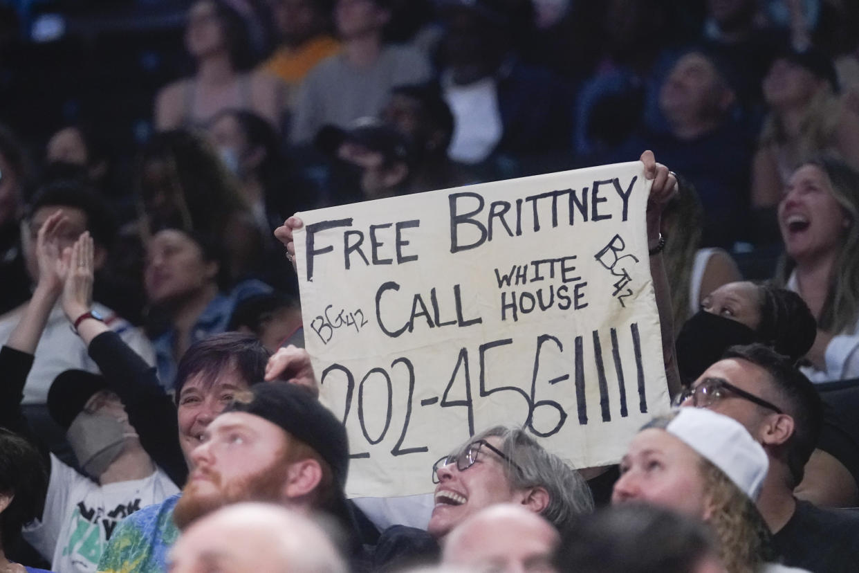 A fan holds up a sign urging other fans to call and pressure the White House to free seven-time WNBA All-Star Brittney Griner from Russian custody during the second half of a WNBA basketball game between the New York Liberty and the Seattle Storm, Sunday, June 19, 2022, in New York. The Storm won 81-72. (AP Photo/Mary Altaffer)