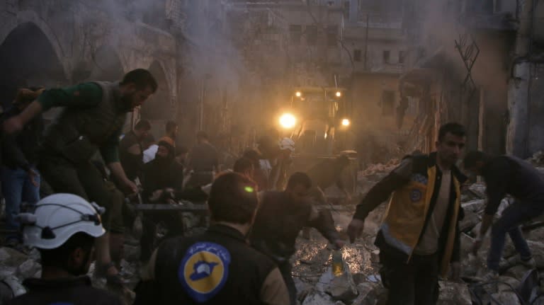 Syrian civil defence workers search for survivors after an air strike in the rebel-held town of Harem in Idlib province on March 22, 2018