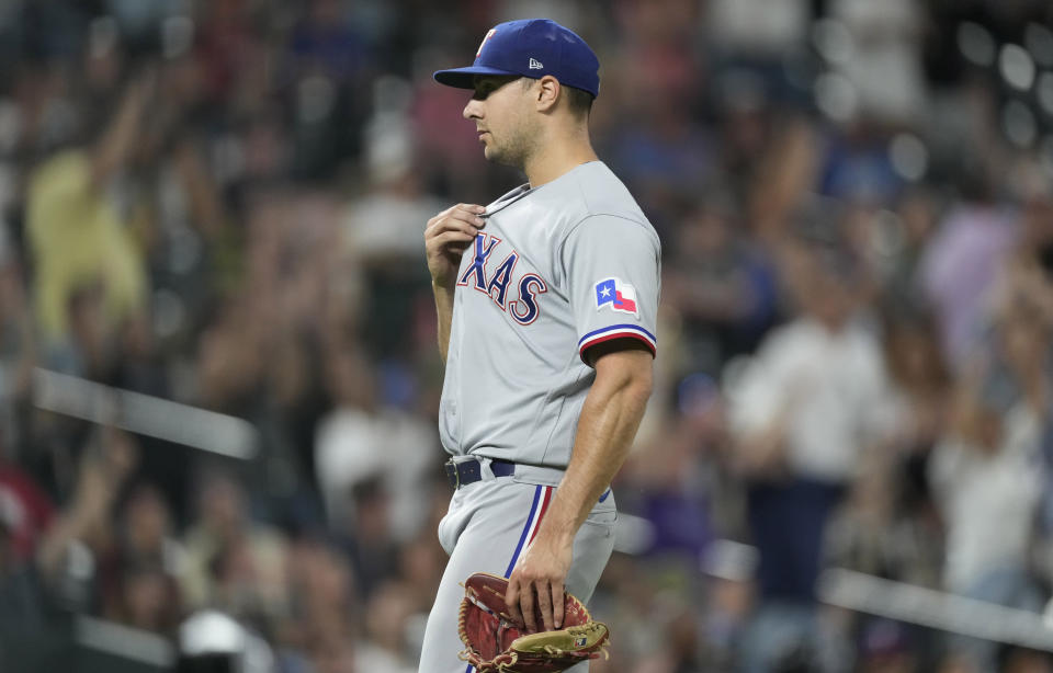 Texas Rangers relief pitcher Brock Burke reacts after giving up a three-run home run to Colorado Rockies' C.J. Cron in the seventh inning of a baseball game Tuesday, Aug. 23, 2022, in Denver. (AP Photo/David Zalubowski)