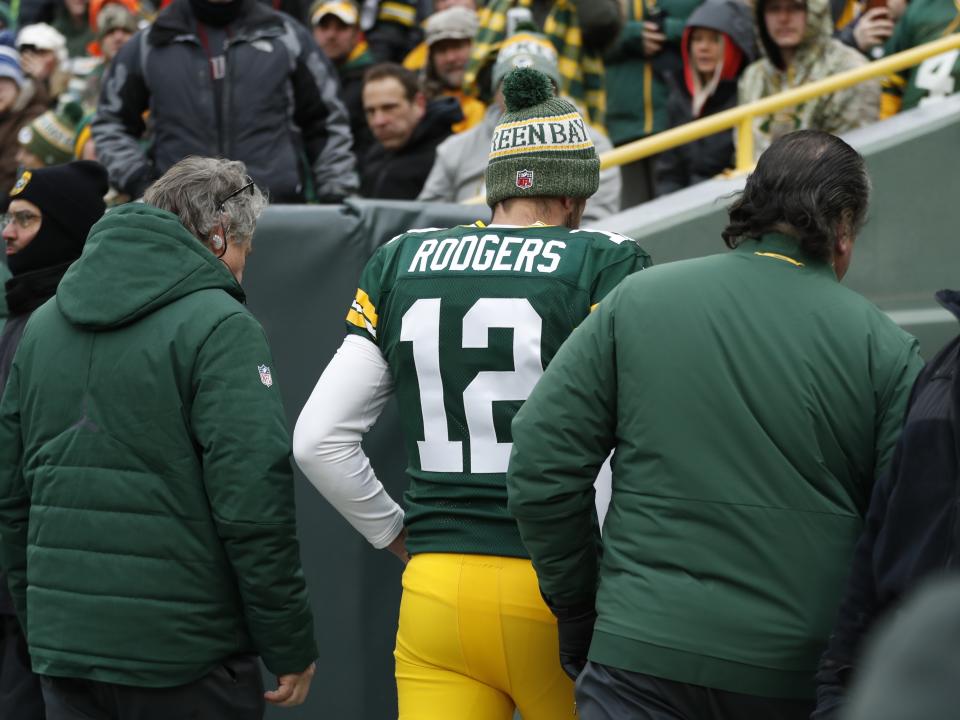 CORRECTS TO REMOVE SCORE- Green Bay Packers' Aaron Rodgers is taken to the locker room to be evaluated during the first half of an NFL football game against the Detroit Lions Sunday, Dec. 30, 2018, in Green Bay, Wis. (AP Photo/Matt Ludtke)