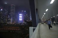 In this Thursday, May 28, 2020, photo, a man walks on a bridge in the Central district of Hong Kong. Hong Kong has been living on borrowed time ever since the British made it a colony nearly 180 years ago, and all the more so after Beijing took control in 1997, granting it autonomous status. A national security law approved by China's legislature Thursday is a reminder that the city's special status is in the hands of Communist Party leaders who have spent decades building their own trade and financial centers to take Hong Kong's place. (AP Photo/Kin Cheung)