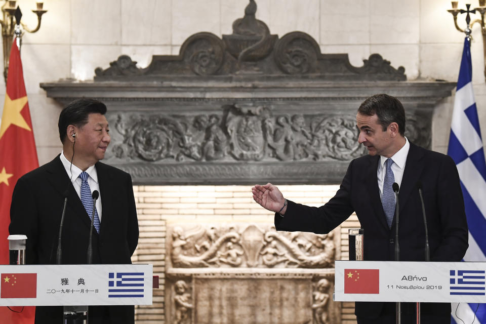 China's President Xi Jinping, left, and Greece's Prime Minister Kyriakos Mitsotakis, attend a joint media conference following their meeting at Maximos Mansion in Athens, Monday, Nov. 11, 2019. Xi Jinping is in Greece on a two-day official visit. (Aris Messinis/Pool via AP)