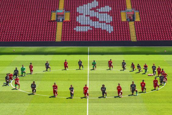 Liverpool’s players take a knee (Liverpool FC via Getty)