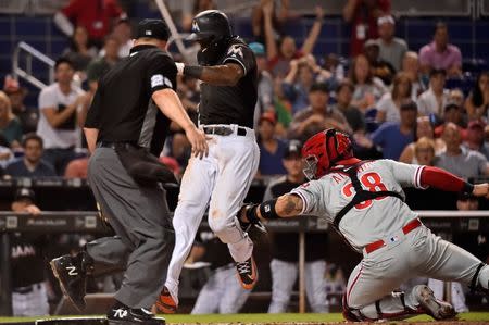 Jul 13, 2018; Miami, FL, USA; Miami Marlins left fielder Cameron Maybin (1) is tagged out at the plate by Philadelphia Phillies catcher Jorge Alfaro (38) in the sixth inning at Marlins Park. Mandatory Credit: Jasen Vinlove-USA TODAY Sports