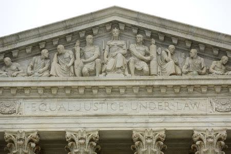 The phrase "Equal Justice Under Law" adorns the west entrance to the U.S. Supreme Court building in Washington December 3, 2014. REUTERS/Jonathan Ernst