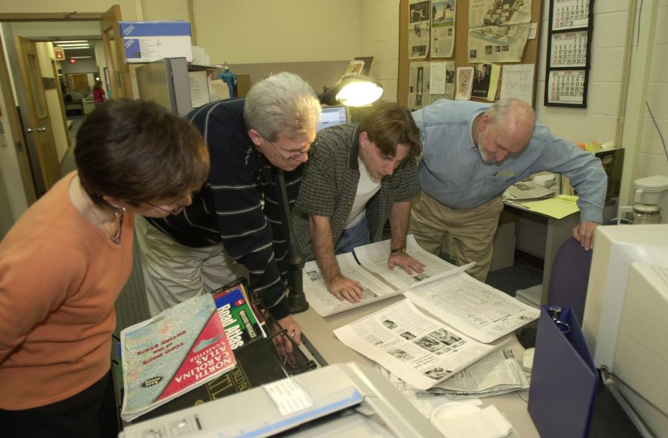 From left, designer Mary Peskin, Executive Editor/ Associate Publisher Allen Parsons, designer Tim Griggs and former Executive Editor Charles Anderson look over final proofs of the Sports section during the StarNews' redesign in 2002. Anderson recently passed away at age 84.