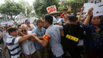 Police try to stop protesters who say they are demanding cleaner waters in the central regions after mass fish deaths in recent weeks, in Hanoi, Vietnam May 1, 2016. REUTERS/Kham