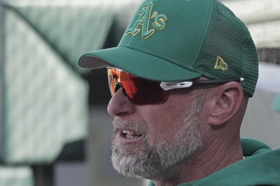 Oakland Athletics manager Mark Kotsay watches during the ninth inning of a spring training baseball game against the Kansas City Royals Tuesday, March 22, 2022, in Surprise, Ariz. (AP Photo/Charlie Riedel)