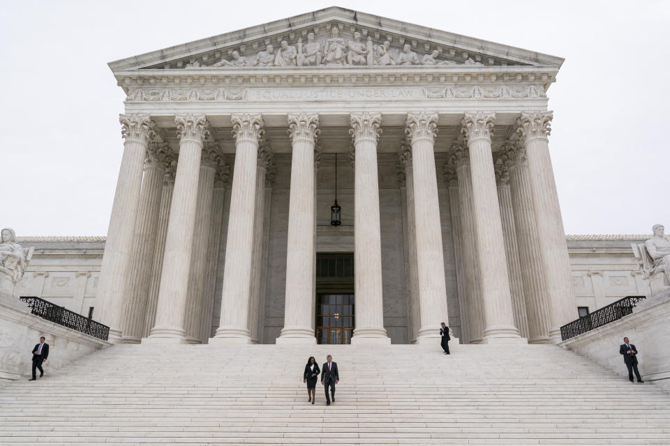 Justice Ketanji Brown Jackson, center left, is escorted by Chief Justice of the United States John Roberts following her formal investiture ceremony at the Supreme Court in Washington, Friday, Sept. 30, 2022. (AP Photo/J. Scott Applewhite)