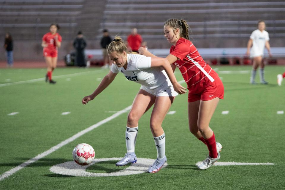 Pueblo West’s Jocelyn Thompson, left, and Pueblo Centennial’s Tori Velasquez battle for possession during a matchup at Dutch Clark Stadium on Thursday, April 7, 2022.