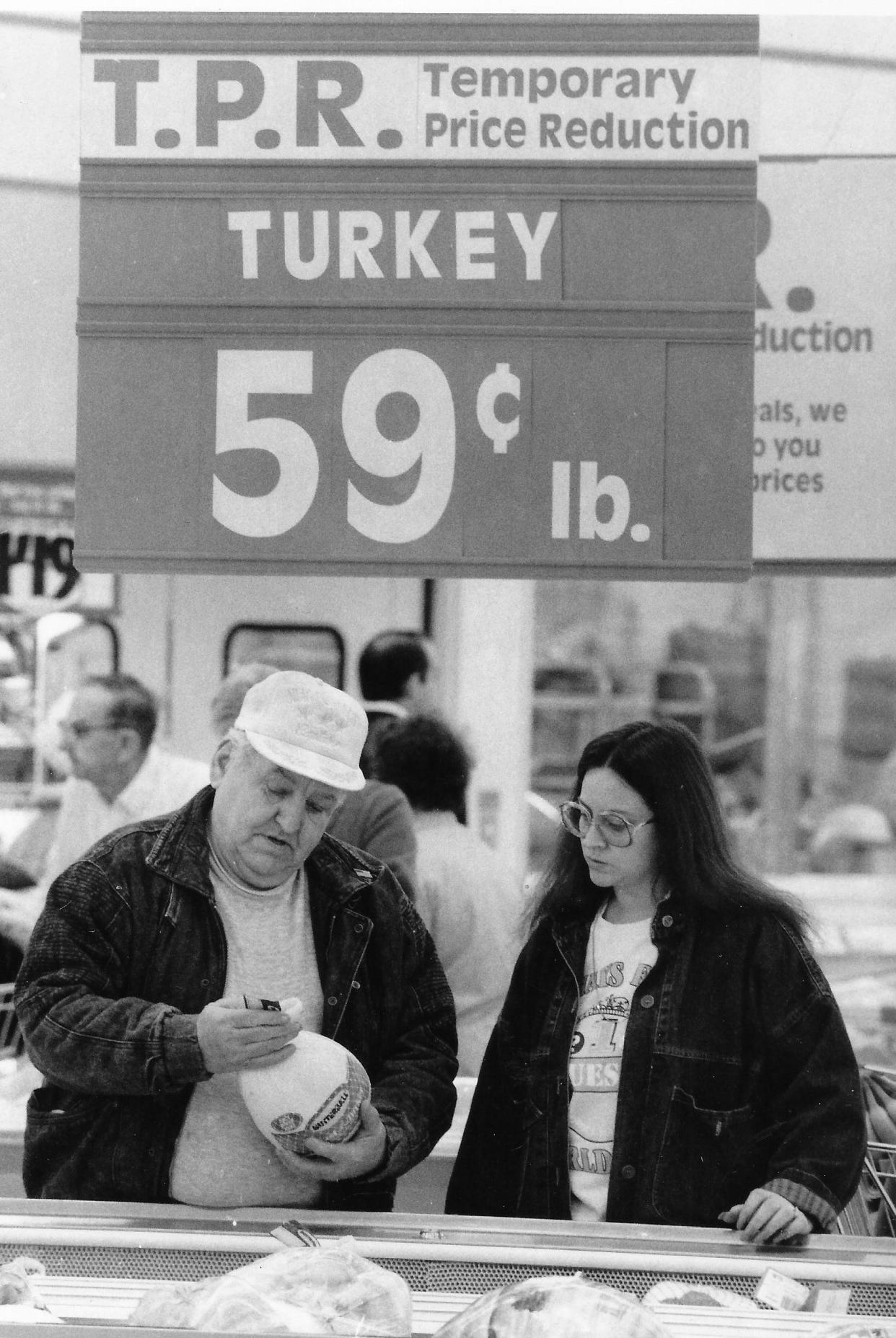 Kenmore neighbors Les McDowell and Sue Greene look at turkeys in the meat section of the Twin Valu store in Cuyahoga Falls on March 6, 1989. The 24-hour store offered turkey at a “temporary price reduction” of 59 cents a pound at the grand opening.