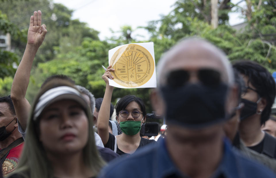 Pro-democracy demonstrators hold a copy of a plaque marking Thailand's transition to democracy during a protest outside the Parliament in Bangkok, Thailand, Thursday, Sept. 24, 2020. Lawmakers in Thailand are expected to vote Thursday on six proposed amendments to the constitution, as protesters supporting pro-democratic charter reforms gathered outside the parliament building. (AP Photo/Sakchai Lalit)