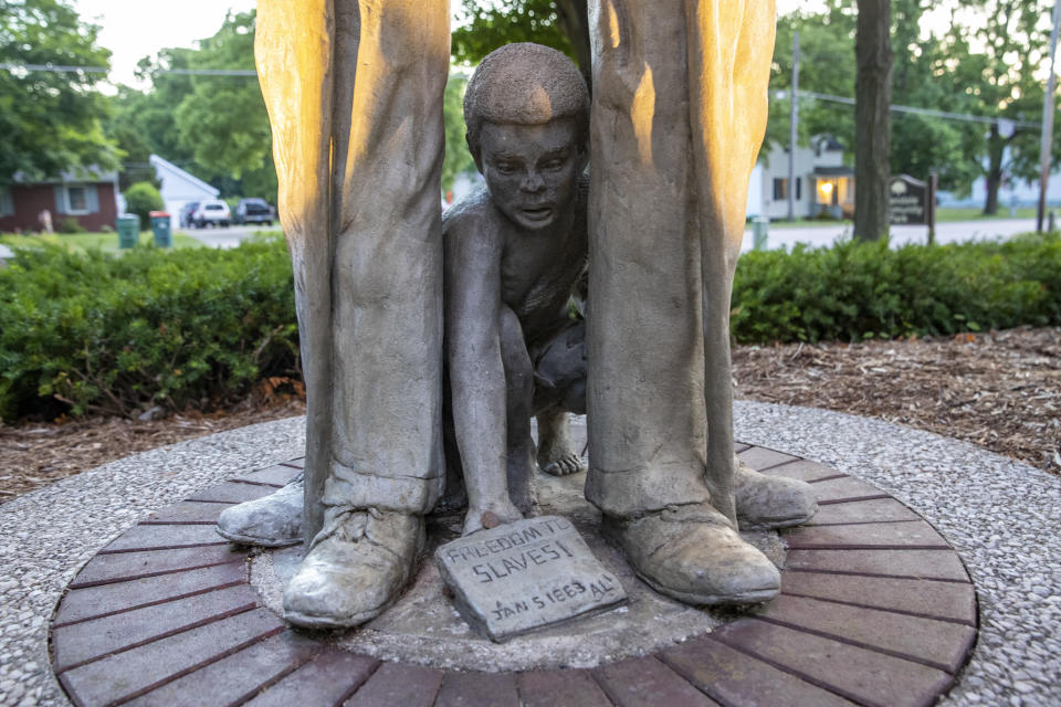 File- This June 30, 2020, file photo shows the Civil War statue at Veterans Garden of Honor in Allendale Township, Mich. A citizens committee in western Michigan has proposed removing a park statue of a Union soldier and Confederate soldier standing back to back as a slave child kneels between them. The Garden of Honor Memorial Committee presented its suggestion Monday, May 24, 2021, to the Allendale Township board which could vote June 14 on the statue’s future. (Cory Morse/The Grand Rapids Press via AP, File)